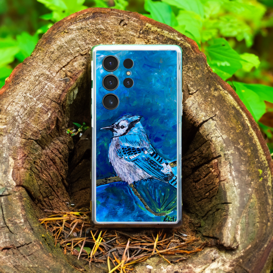 A phone case printed with the artwork "Blue Jay #1" by Robert Lariviere is sitting in a hollowed out tree stump in nature.